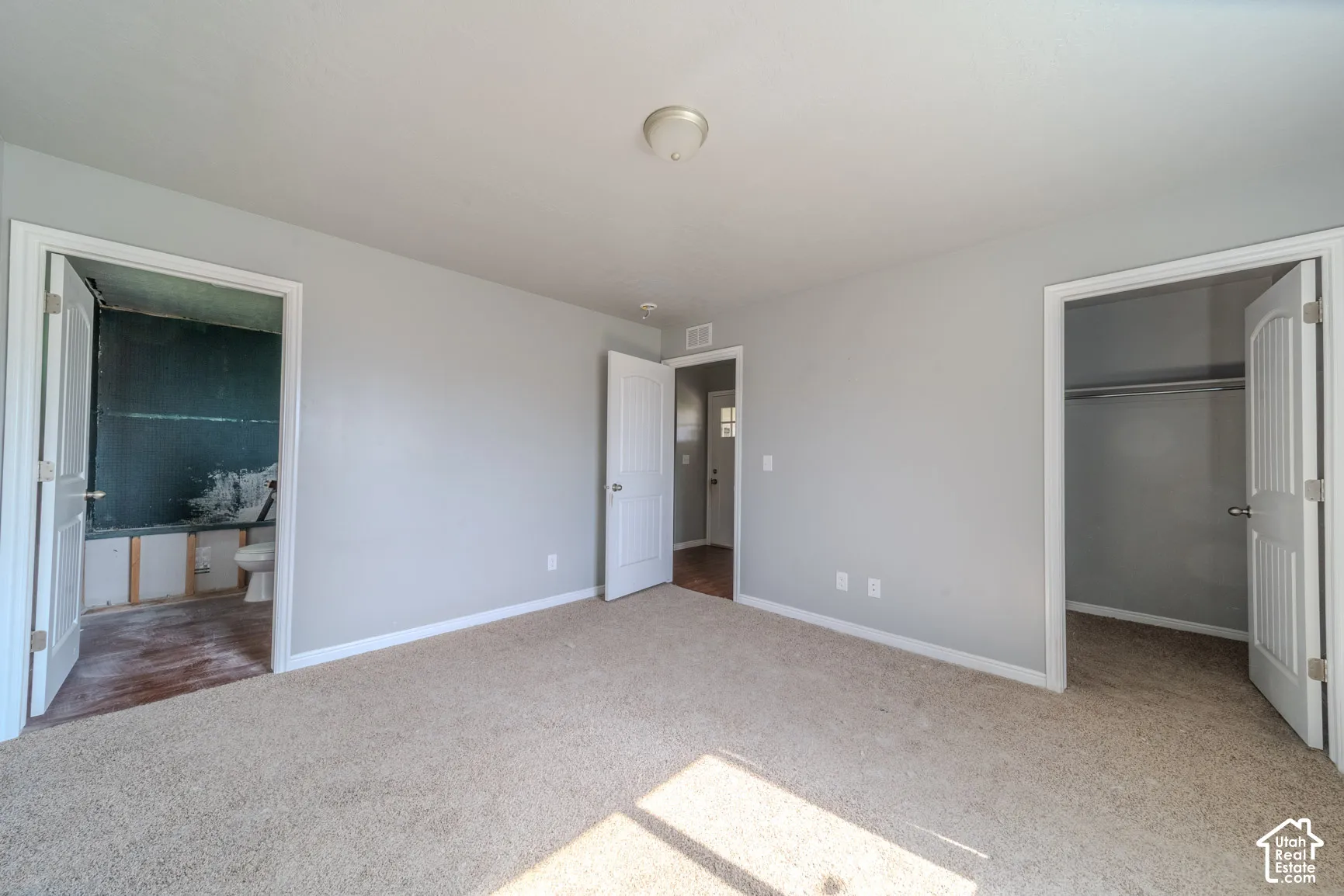 Carpeted interior space with light gray walls