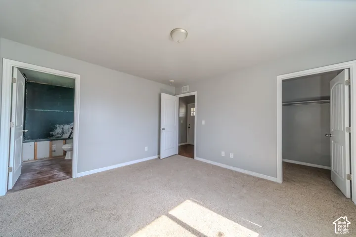 Carpeted interior space with light gray walls