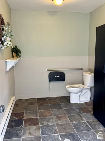 Womens Restroom Slate tile flooring complemented by a two-tone wall finish