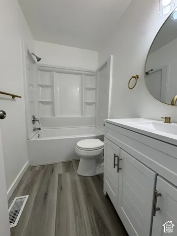 White vanity with brushed nickel hardware, integrated sink, and white countertop