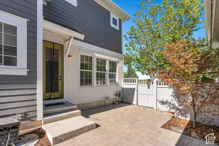 Pavered patio area with privacy fencing and a gated entry