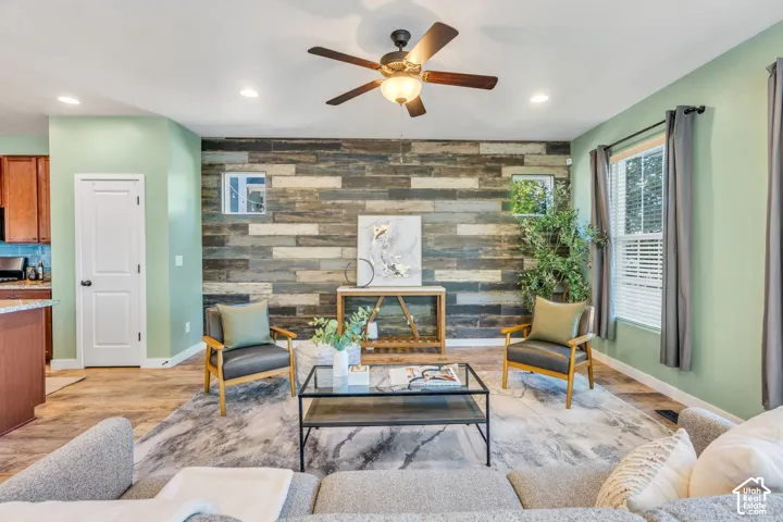Wood-finish flooring throughout, complemented by a decorative wood-panel accent wall