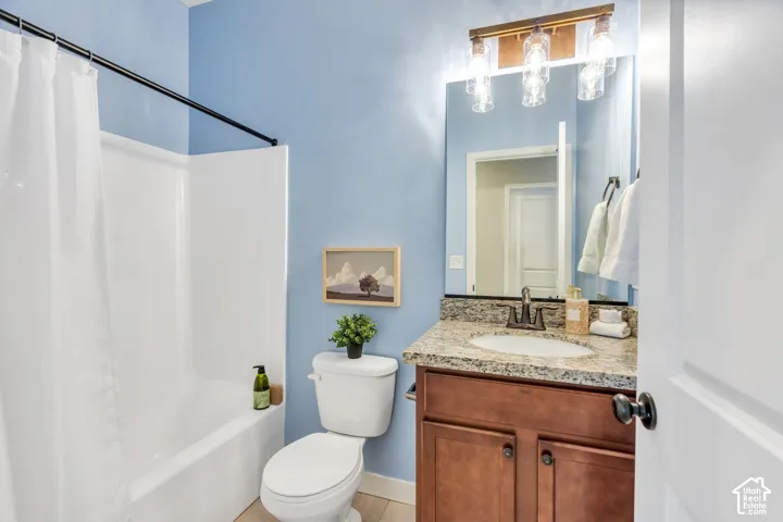 Built-in vanity with a circular basin sink, granite-style countertop, and wood-finish cabinetry
