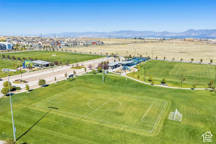 Expansive green spaces featuring multiple sports fields, paved pathways, and recreational facilities