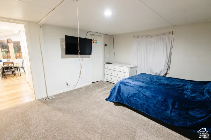 Gray carpet flooring, white painted walls, white trim, and a built-in recessed light fixture