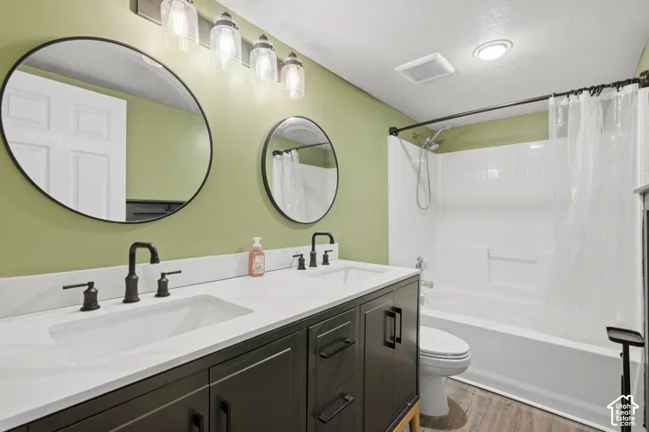 Dual vanity with integrated sinks, dark cabinetry, and matte black fixtures