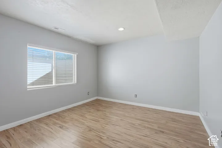 Wood-finish flooring with white baseboards