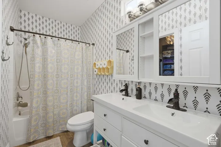 Double vanity with integrated sinks, white cabinetry, and bronze-finish faucets