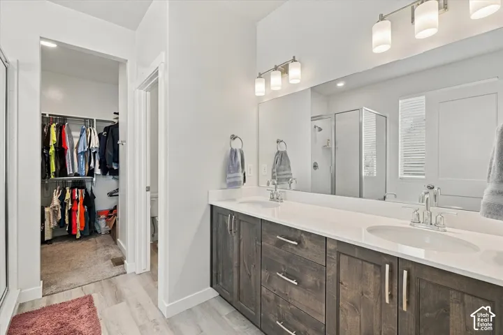 Dual vanity with wood-finish cabinetry and white countertops