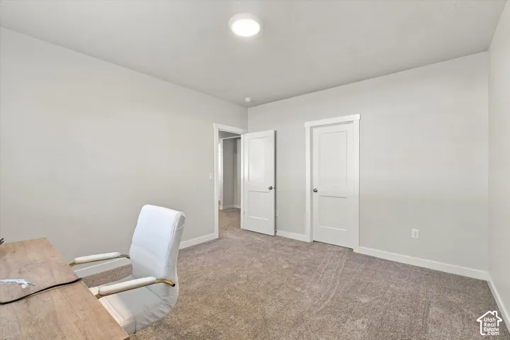 Neutral tone wall paint, carpeted flooring, and white trim throughout