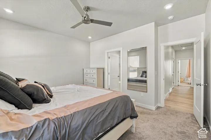 Recessed lighting, ceiling fan, white trim, light gray wall paint, and light-toned carpet flooring