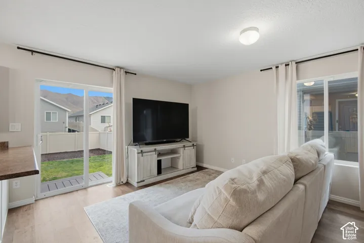 Light wood-finish flooring with a ceiling-mounted light fixture