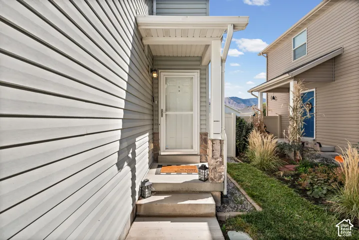 Covered front entry with concrete steps and stone accents