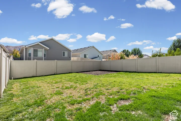 Expansive grass lawn with a perimeter fence