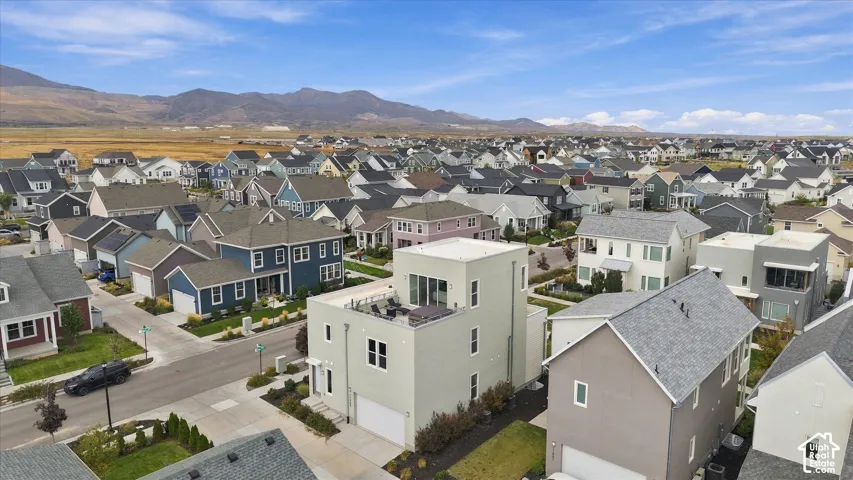 Aerial view showcasing a newer residential community nestled against mountain foothills