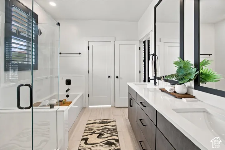 Dual vanity with integrated sinks and dark wood-finish cabinetry