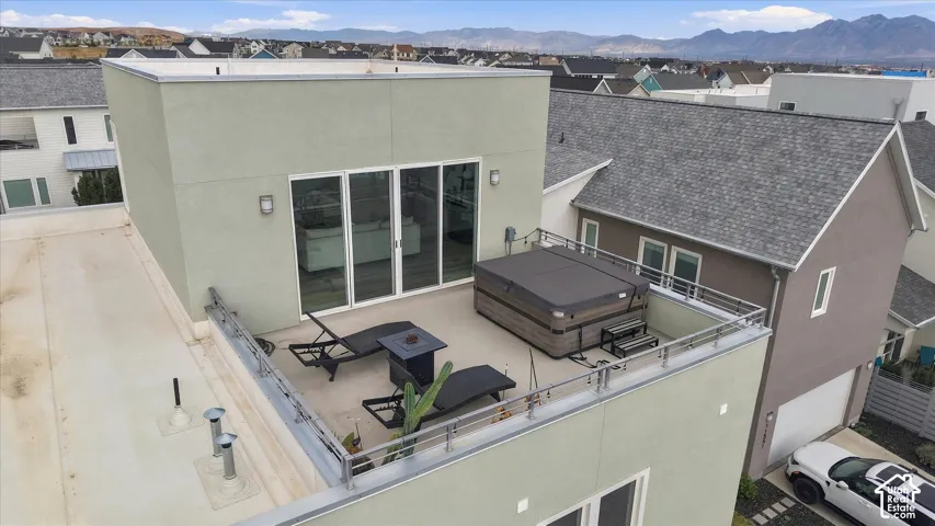 Modern rooftop terrace featuring composite decking, integrated seating areas, and expansive mountain vistas