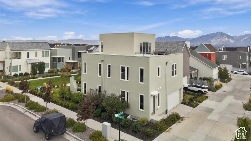 Contemporary stucco exterior with a flat roofline, integrated garage, and multiple windows