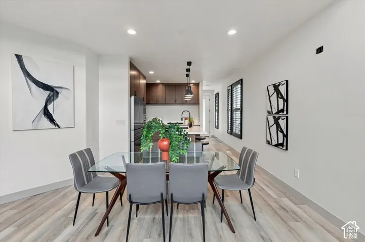 Open-concept dining area with wood-finish flooring
