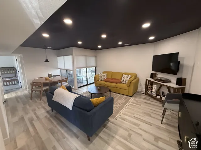 Recessed lighting, wood-finish flooring, sliding glass door, modern ceiling fixture, black ceiling