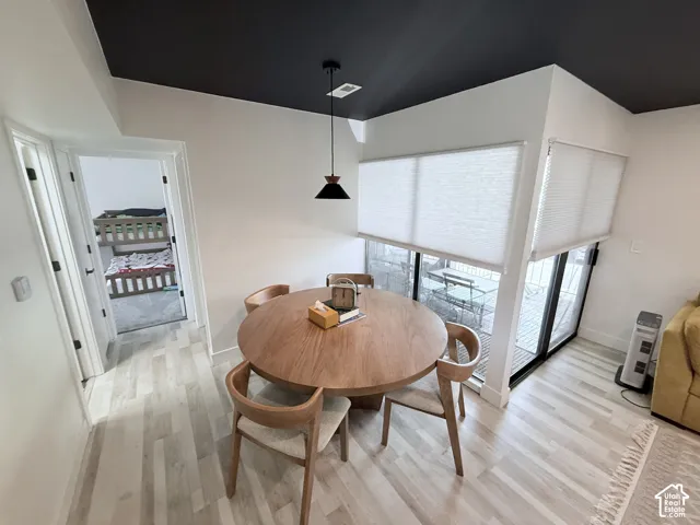 Wood-finish flooring throughout, with a contrasting black ceiling in the dining area