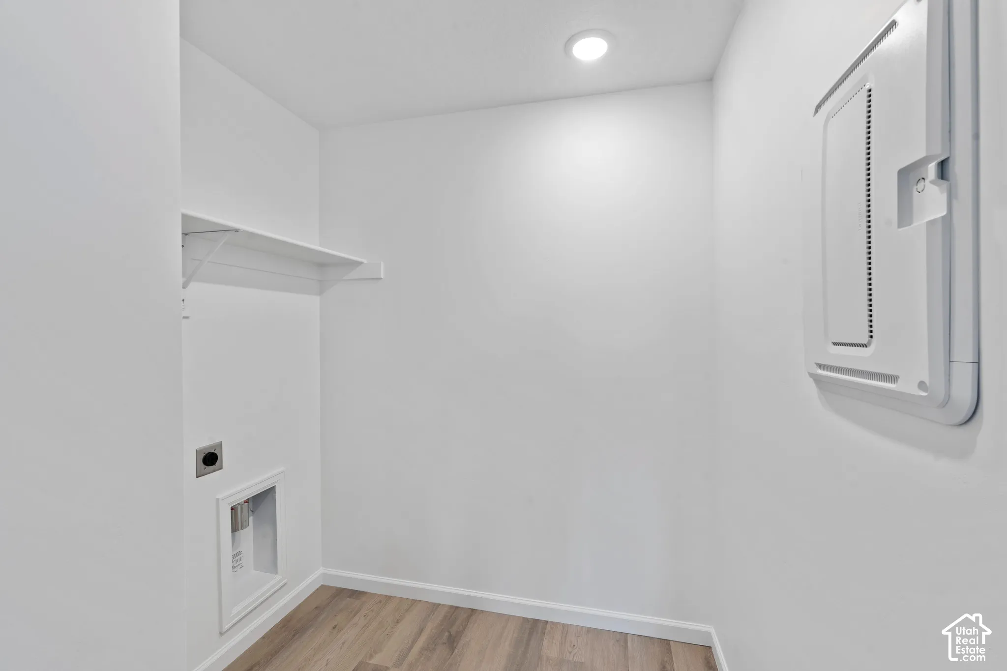 Dedicated laundry area with a white wire shelf, wood-finish flooring, and recessed lighting. HOME TO BE BUILT! Pictures are of another similar Spec and not of this exact home. Colors and other options may vary from those seen here. Please see Sales consul