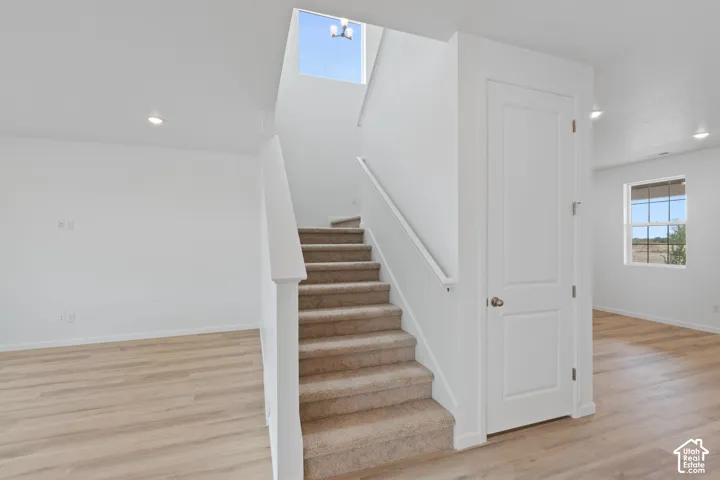 Carpeted staircase with white railing, wood-finish flooring, recessed lighting. HOME TO BE BUILT! Pictures are of another similar Spec and not of this exact home. Colors and other options may vary from those seen here. Please see Sales consultant for deta