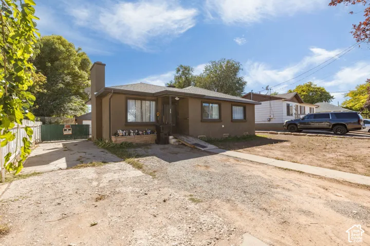 Single-story stucco exterior with a prominent chimney