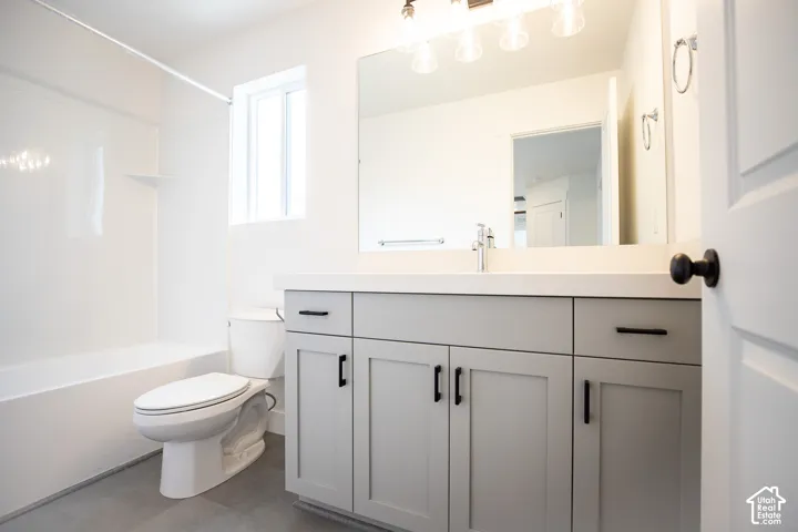 Full secondary bath with painted wood cabinets and quartz slab countertops.