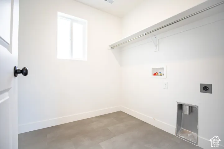 Full-size, dedicated laundry room with natural light and washer/dryer hookups.