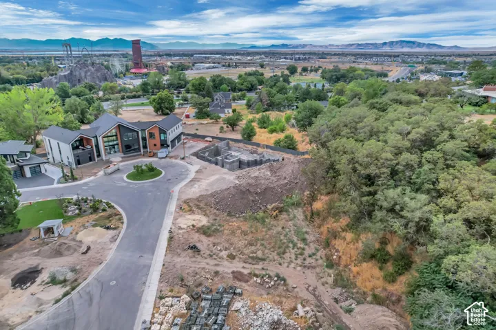 Modern architecture featuring multiple exterior finishes, a private balcony, and a multi-car garage