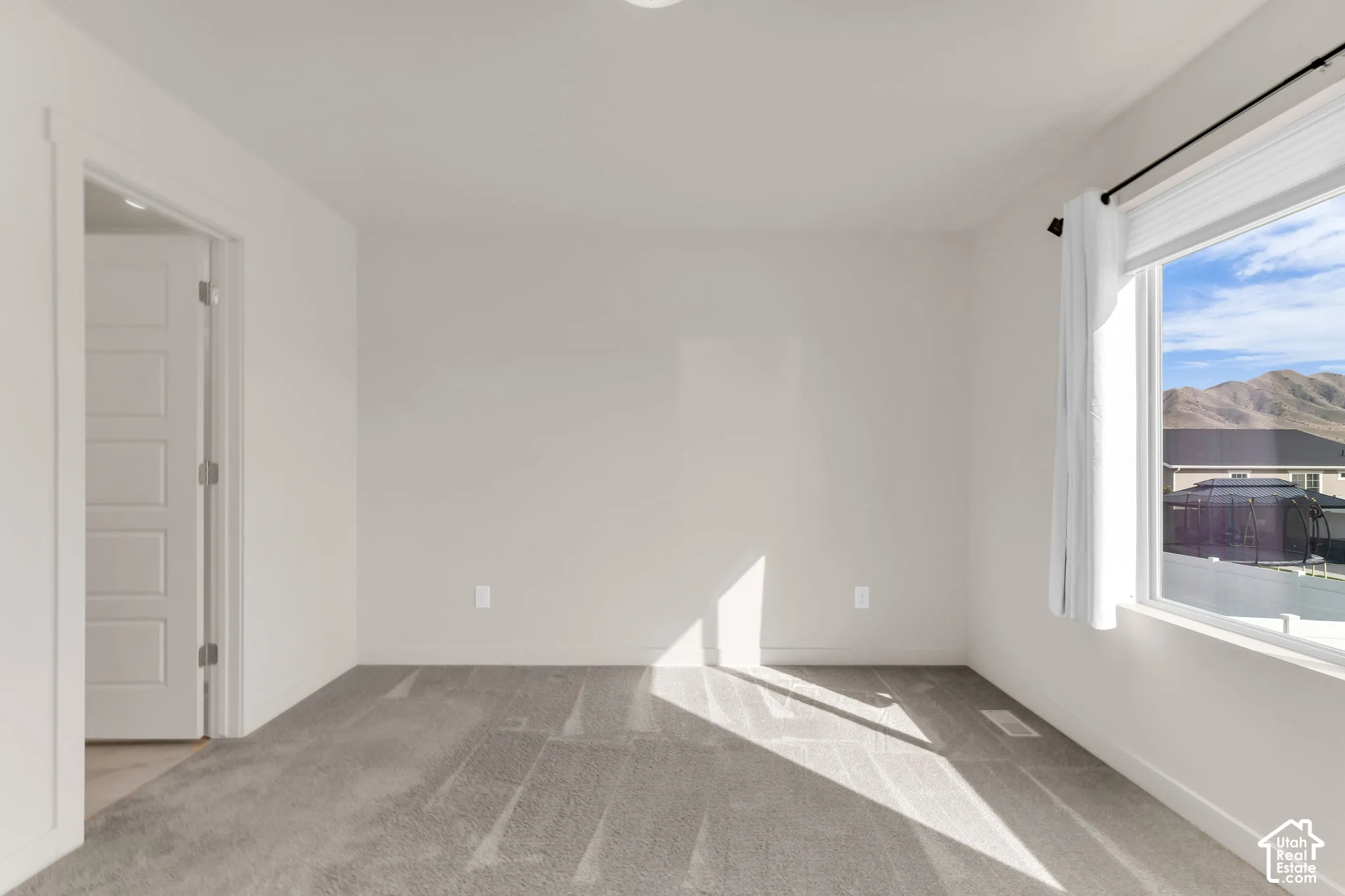 Owner's Suite - Neutral wall finishes, recessed ceiling lighting, a five-panel interior door, and window with mountain scenery