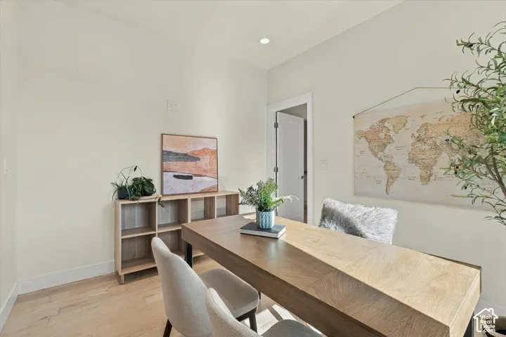 Recessed lighting, light wood-finish flooring, light tone wall paint, a built-in light wood-finish shelving unit, and a solid core door