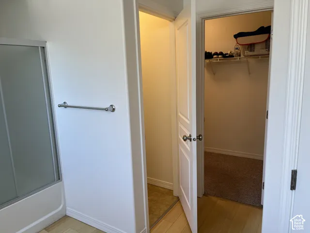Walk-in closet with wire shelving and carpeting