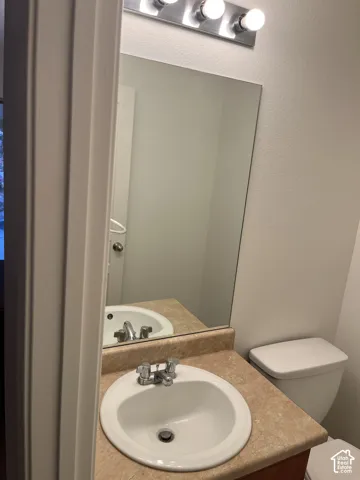 Integrated vanity with a built-in sink, chrome fixtures, and a wall-mounted mirror
