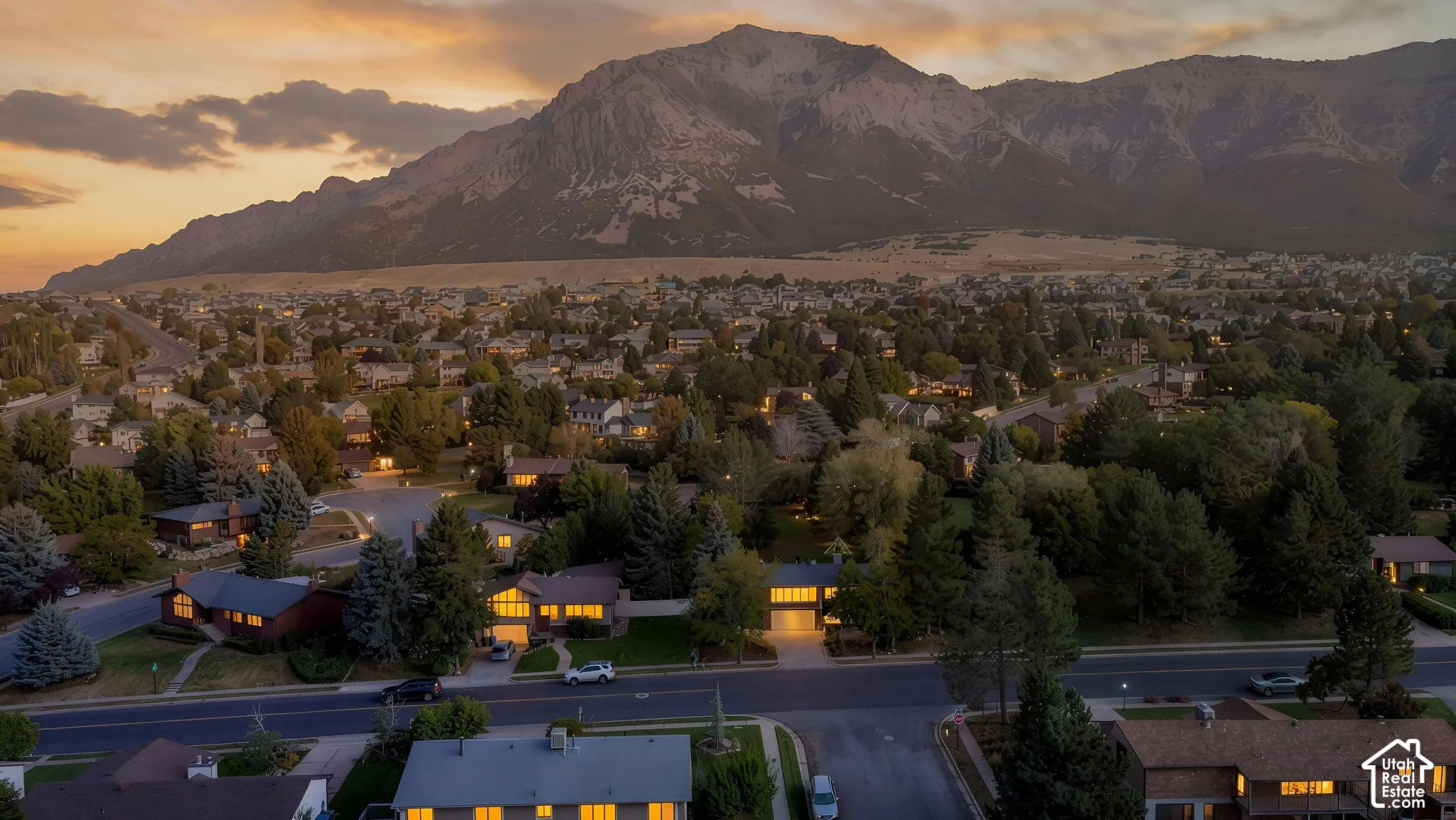Residential neighborhood setting with tree-lined streets and a prominent mountain backdrop