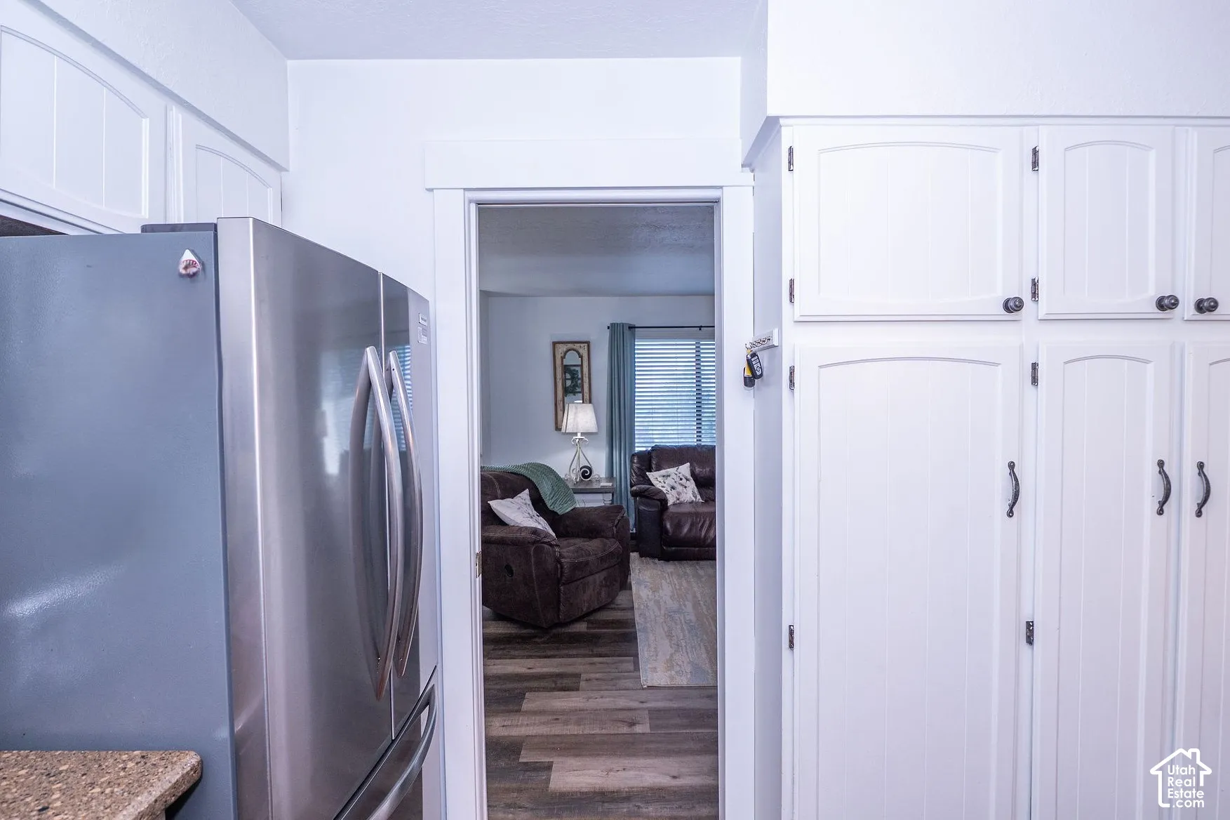Built-in white cabinetry pantry with panel doors and dark hardware