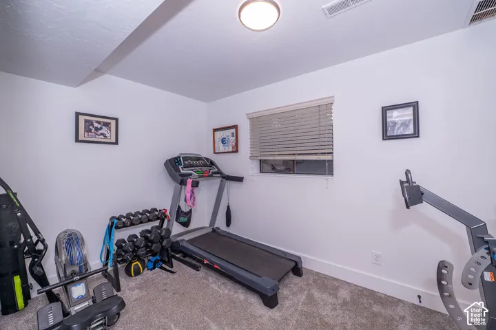 Bedroom 4, with white walls, blinds, 2 closets(one is cedar lined).