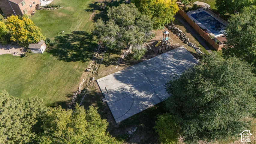 Community sportcourt, playground with mature shade trees, and lush landscaping
