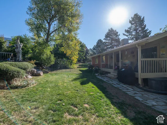 Expansive lawn with mature trees and a stone pathway
