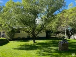 Side view of home -Expansive green lawn with mature trees and a subtle exterior
