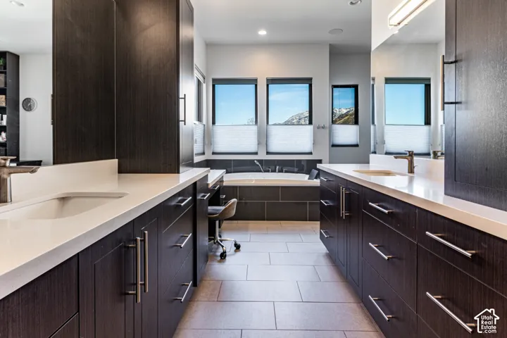 Dual vanities with integrated sinks and white countertops
