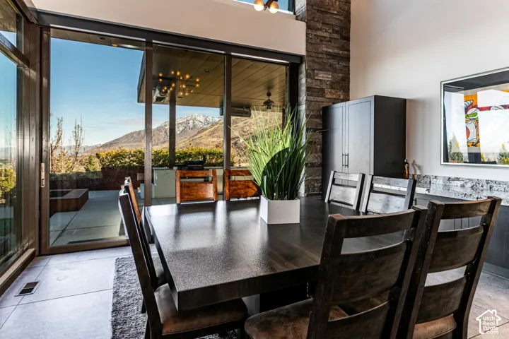 Sliding glass doors opening to a concrete patio, dark wood-finish flooring, stone accent wall, built-in cabinetry, and integrated countertop