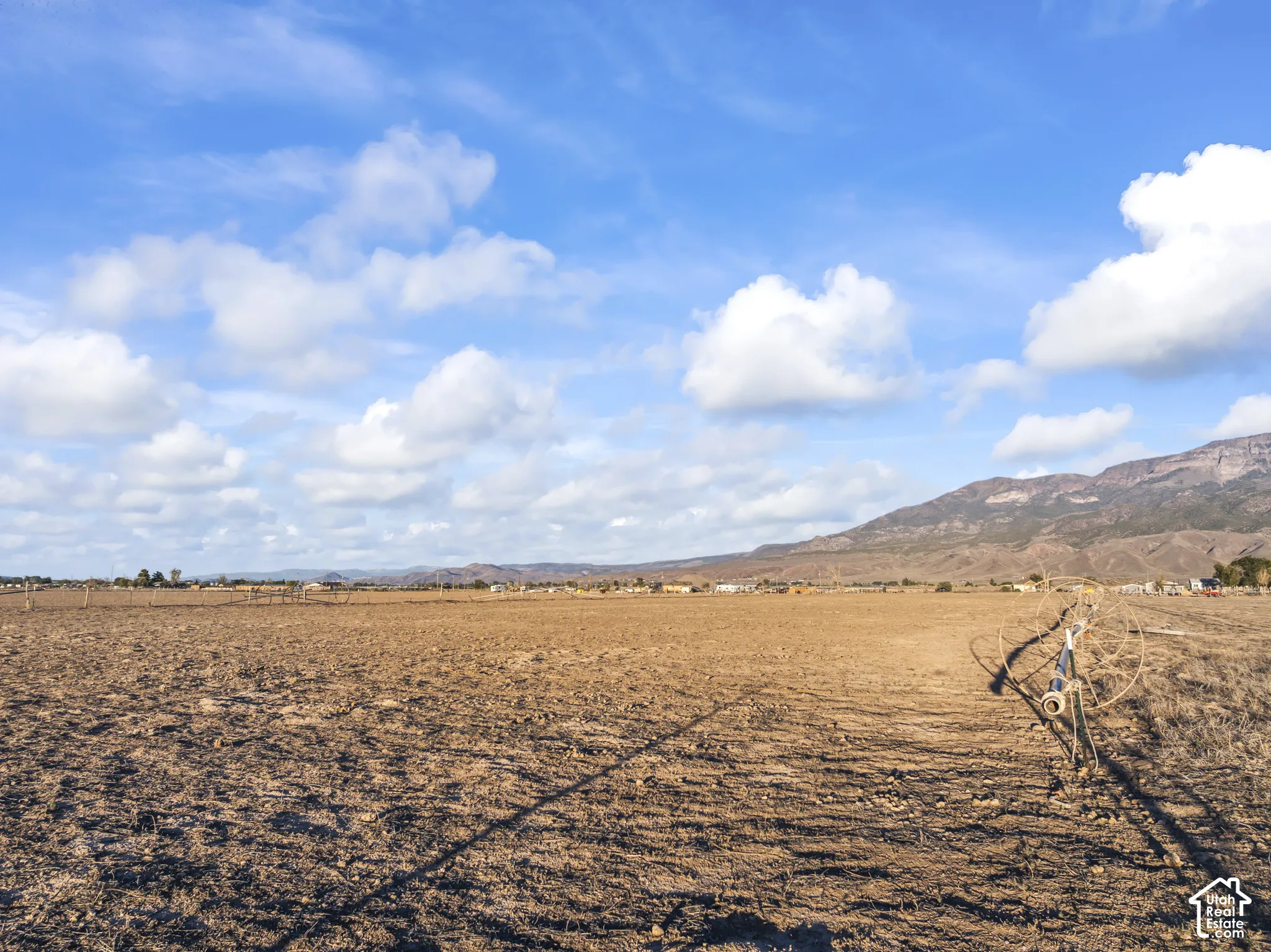 Expansive open land with a distinct mountain backdrop