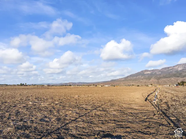 Expansive open land with a distinct mountain backdrop