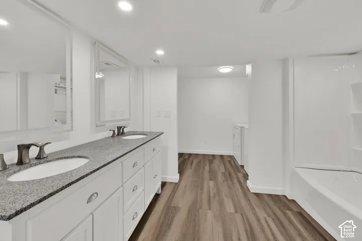 Dual vanity with gray speckled countertop, undermount sinks, and brushed nickel fixtures