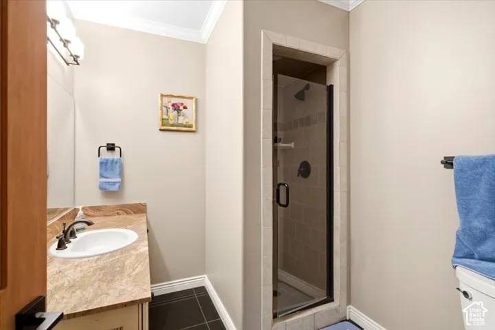 Built-in vanity with an oval sink and stone countertop
