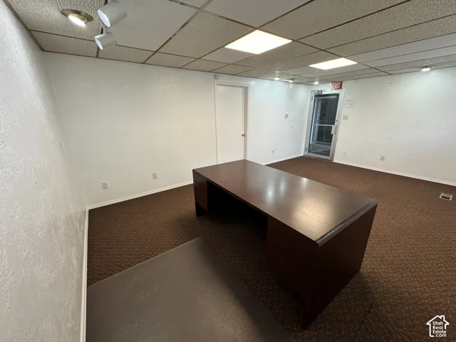 Carpeted flooring, acoustic tile ceiling, track lighting, and recessed lighting