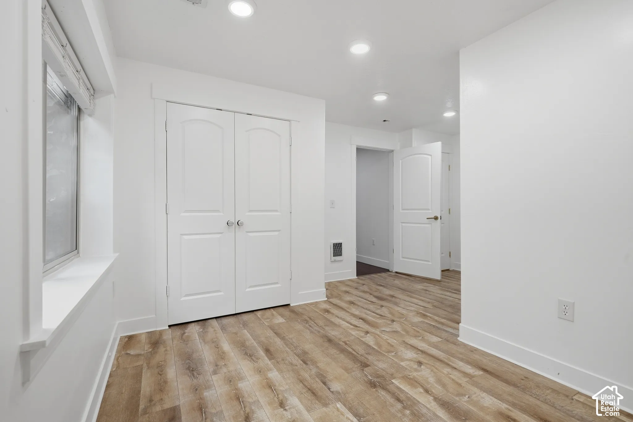 Recessed lighting illumination over wood-finish flooring