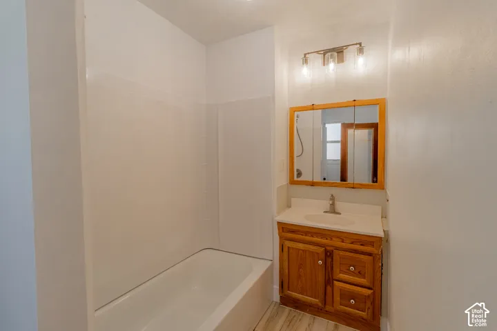 White bathtub with an integrated shower surround